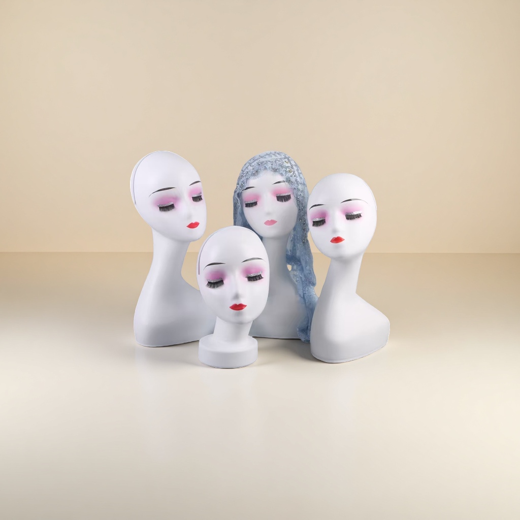 White human-shaped mannequin head, pink blush, red lips, blue lace veil details Picture