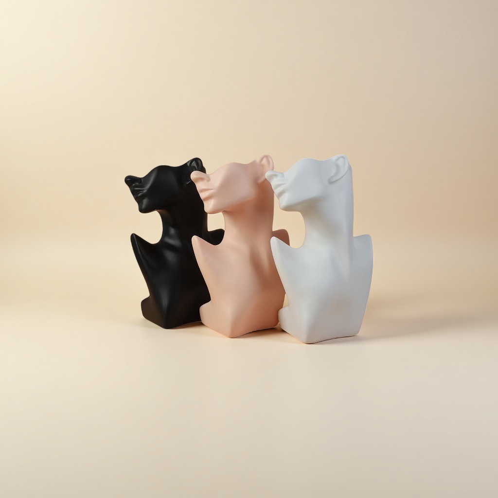Three abstract sculptures of human heads and necks in black, white and white are arranged in combination details Picture