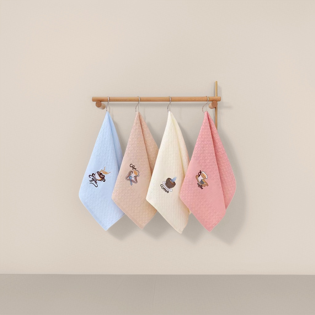 Four coffee-patterned towels are hung on wooden poles in different color combinations