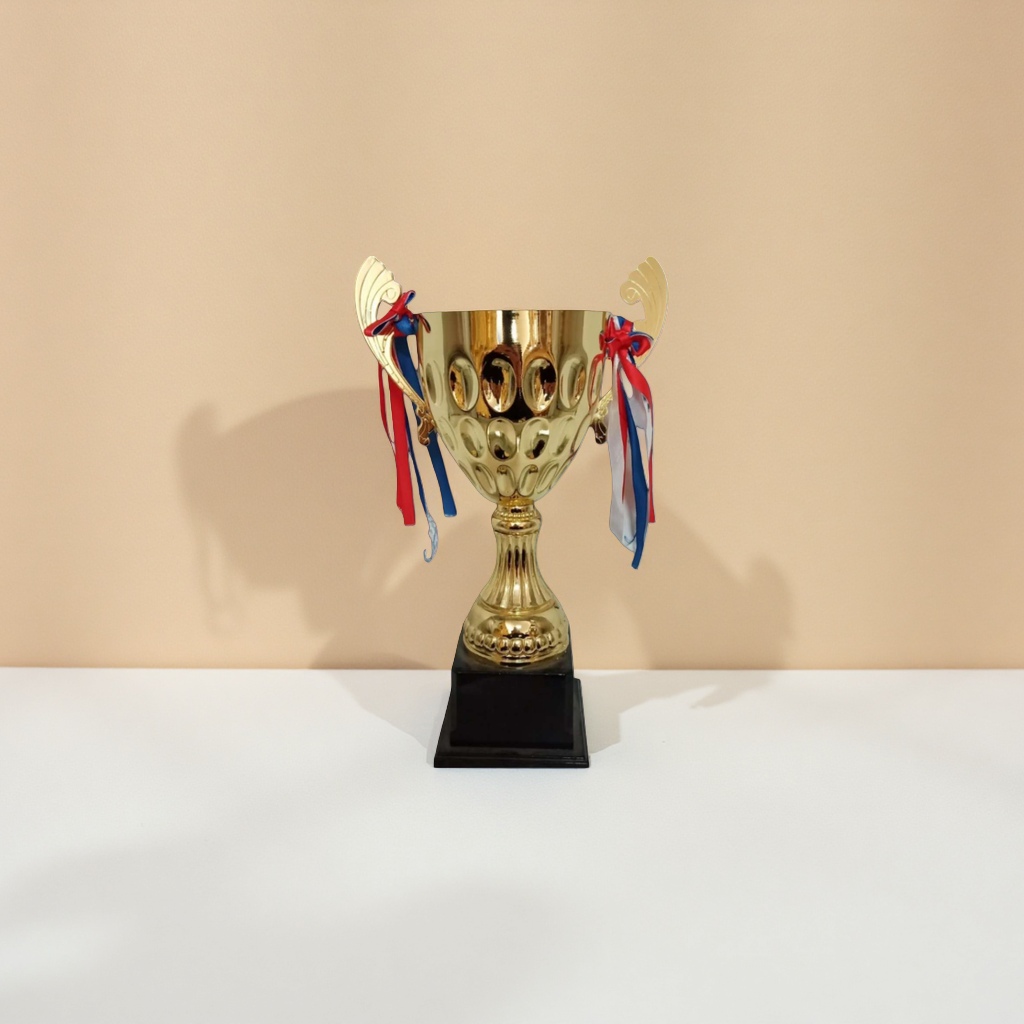 The golden trophy, custom-made for the celebration and award ceremony, features a metallic texture that is high-end and elegant