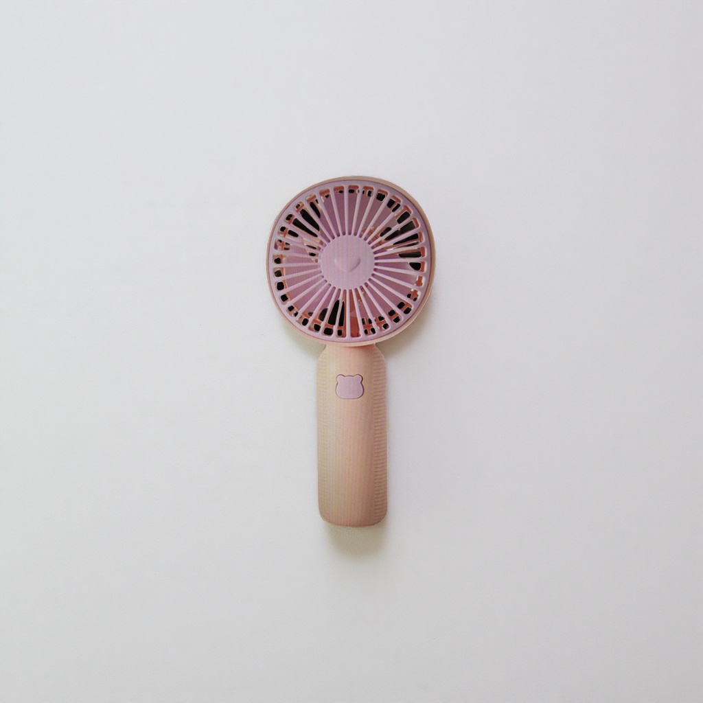 The pink handheld fan body is a portable silent small fan, a summer cooling wonder Application Scenario