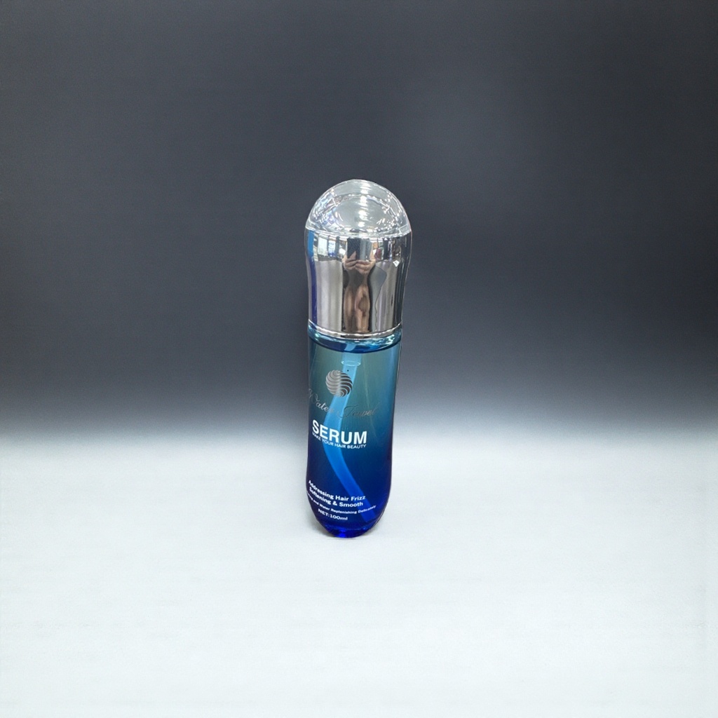 The blue transparent bottle hair care essence repairs damaged hair to make it smooth and shiny details Picture