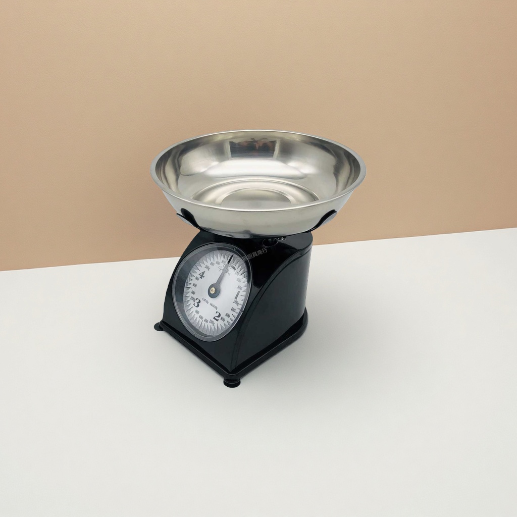 The old-fashioned mechanical scale for kitchen baking weighing has a stable and durable cast iron base