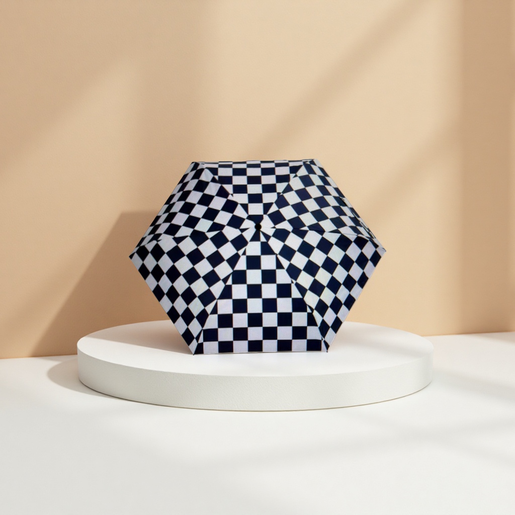 The black and white checkered pattern folding umbrella is portable and suitable for both sun protection and rain