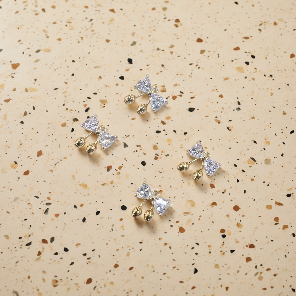 Description: Exquisite bow-shaped ear studs, inlaid with transparent crystals and golden small balls for decoration. Main body: ear studs