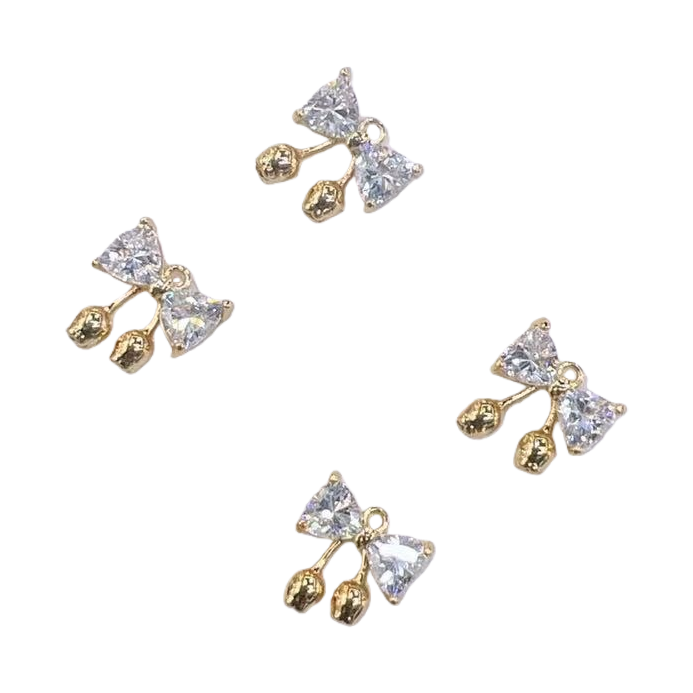 Description: Exquisite bow-shaped ear studs, inlaid with transparent crystals and golden small balls for decoration. Main body: ear studs Item Picture