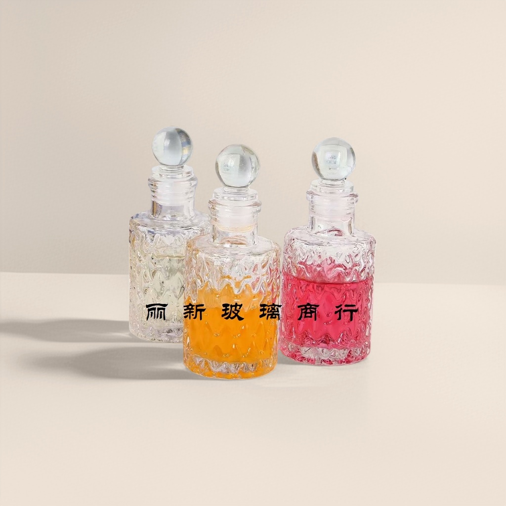 Three transparent glass bottles containing colored liquid, round glass balls, with caps and a background of a book photo frame Specification image