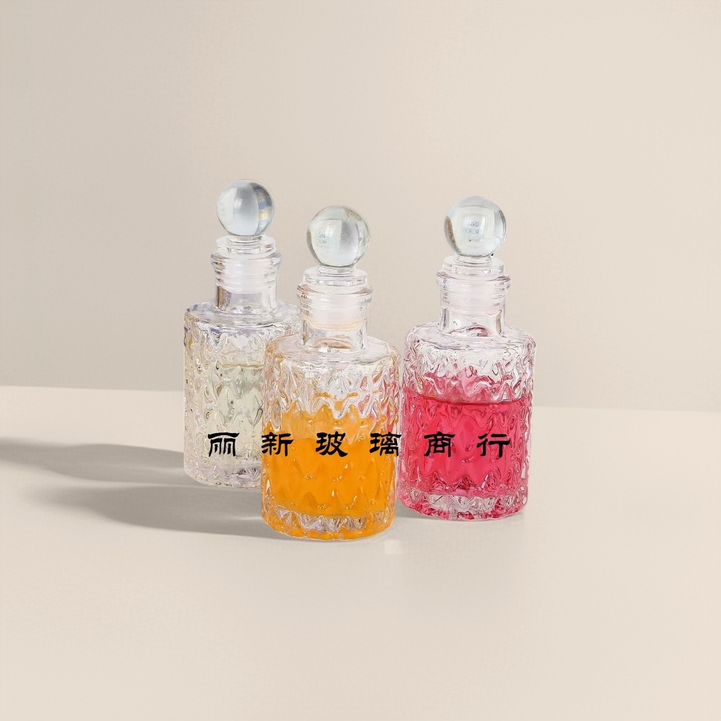 Three transparent glass bottles containing colored liquid, round glass balls, with caps and a background of a book photo frame details Picture