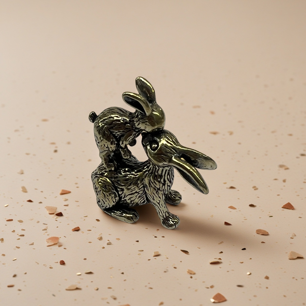 A creative home decoration piece featuring a combination of brass decorative sculptures of kissing rabbits details Picture