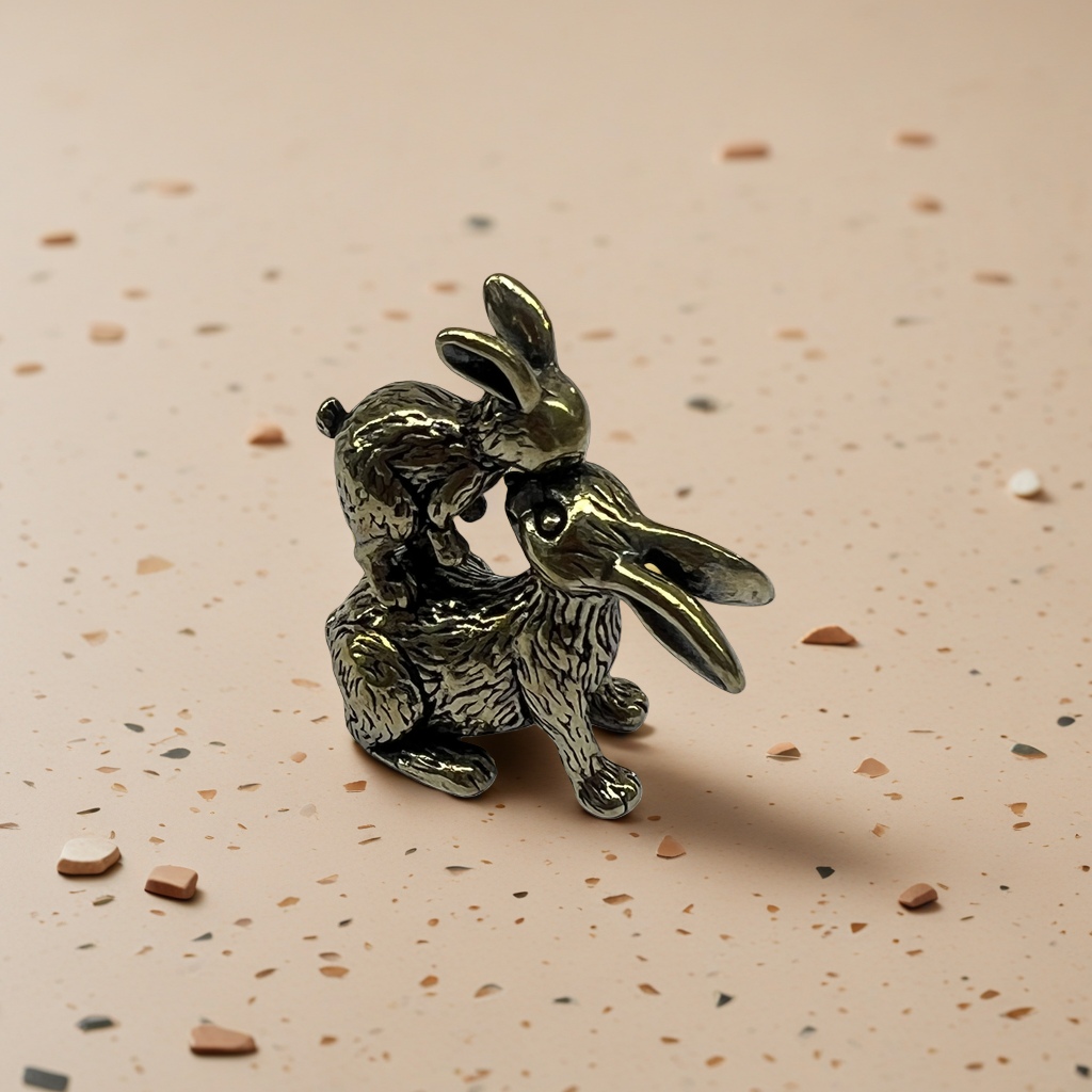 A creative home decoration piece featuring a combination of brass decorative sculptures of kissing rabbits