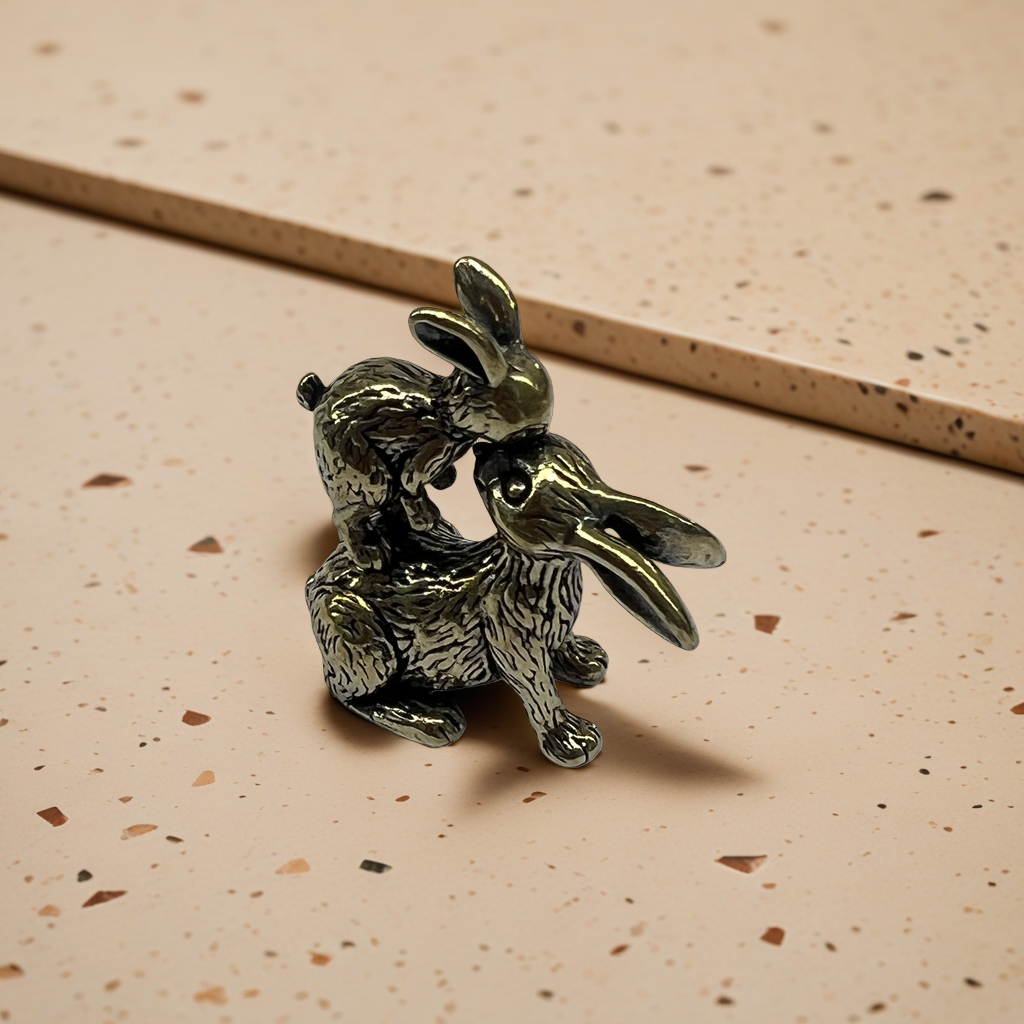 A creative home decoration piece featuring a combination of brass decorative sculptures of kissing rabbits Specification image