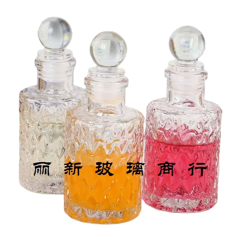 Three transparent glass bottles containing colored liquid, round glass balls, with caps and a background of a book photo frame Item Picture
