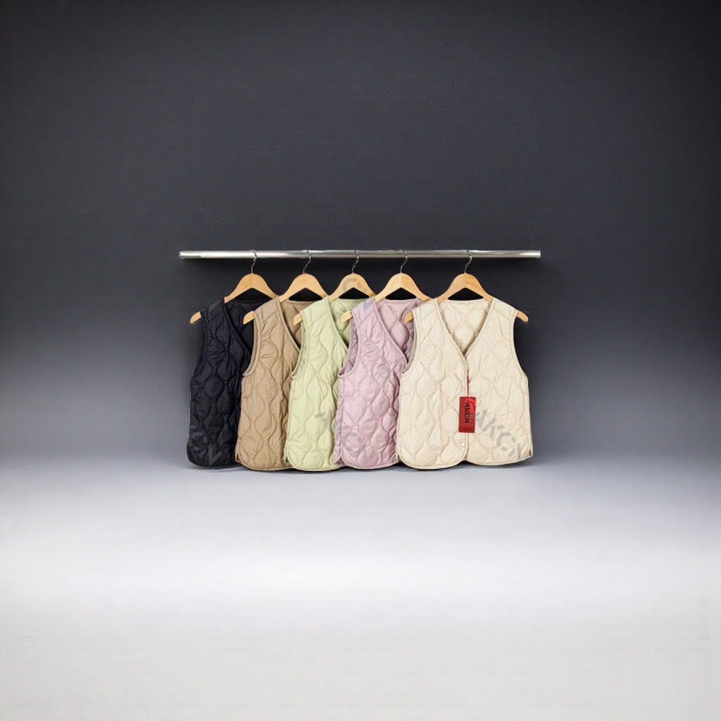 Description words: Multi-color quilted vest Main body: Five quilted sleeveless vests of different colors, hung on a hanger for display. The colors include black, khaki, light green, light pink and off-white details Picture