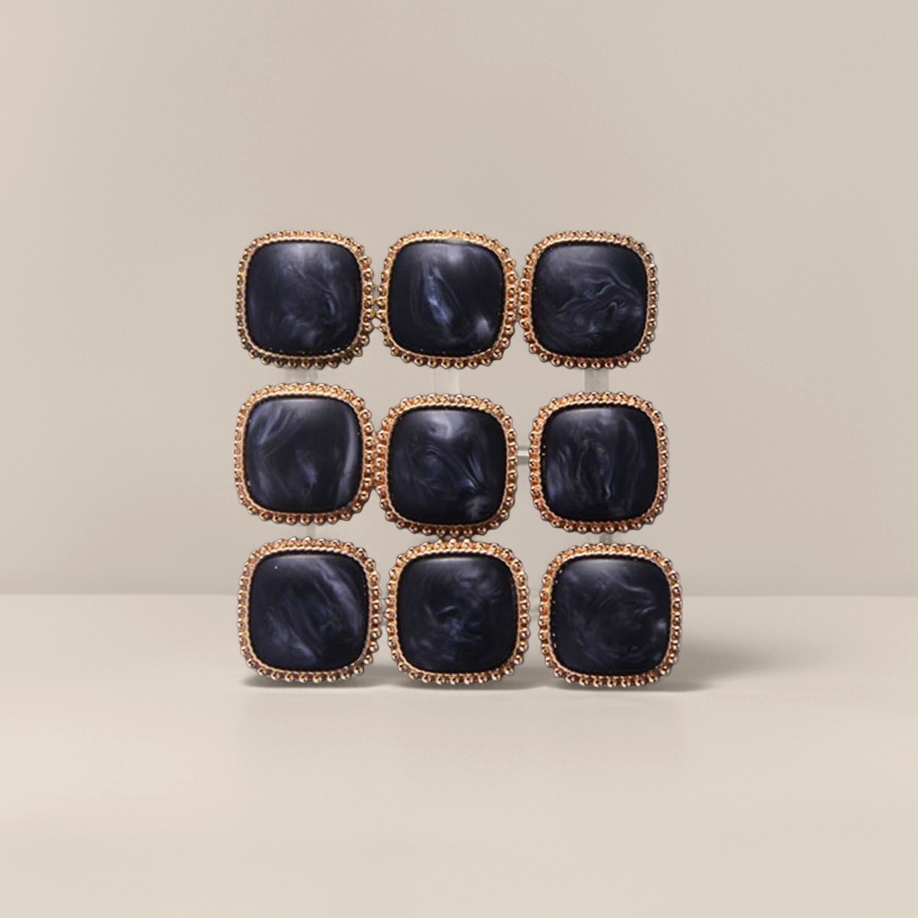 Black square gemstone with golden buttons
