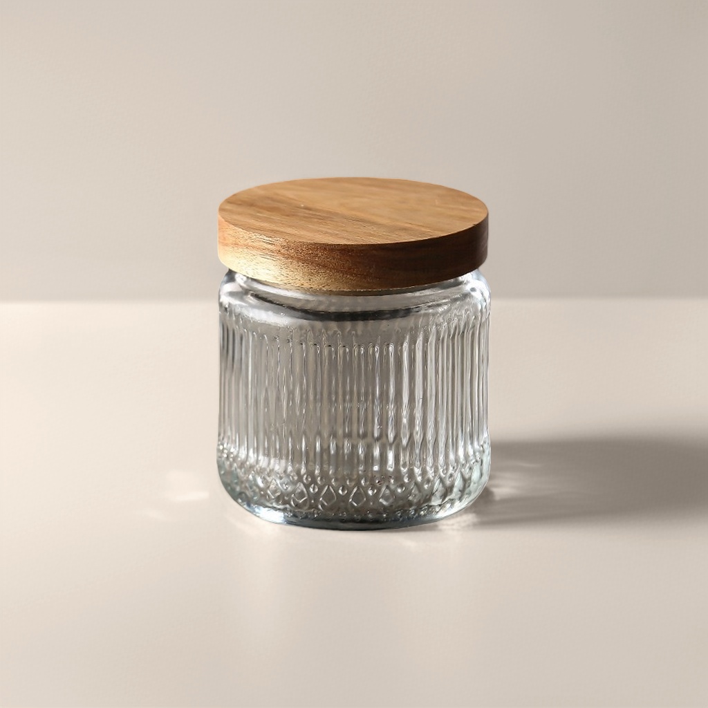 A transparent glass storage jar with a wooden lid for household kitchen storage