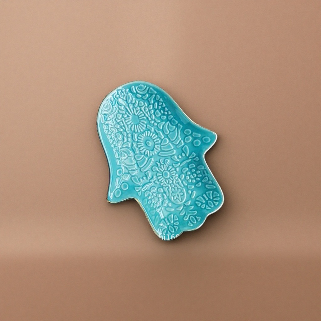 Green hand shape, blue ceramic plate, floral geometric relief with golden edges details Picture