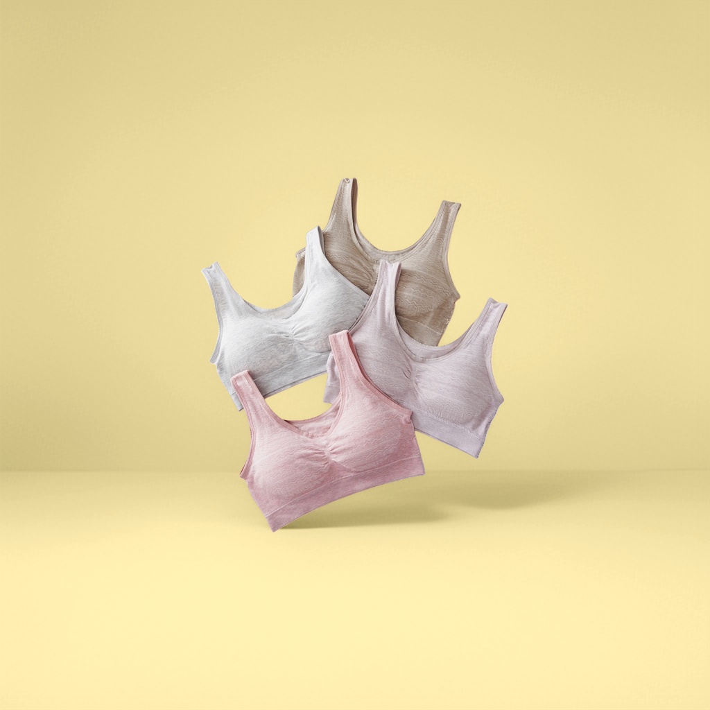 The light grey, beige, light pink and light pink bras without underwire are laid flat to show the comfort of light-colored bras for women in summer details Picture