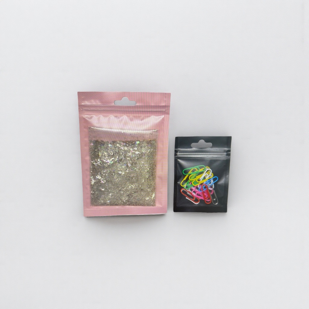 Pink sealed bag with sequins, black sealed bag with colorful paper clips stationery storage set