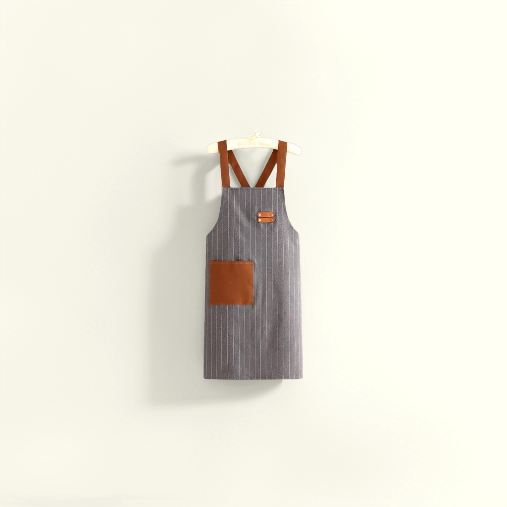 A grey striped apron with brown shoulder straps and pockets is a fashionable kitchen home stain-resistant apron details Picture