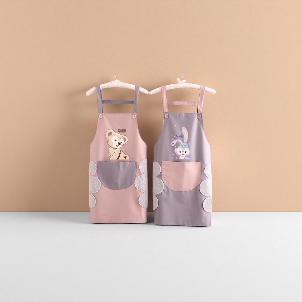 A pink and grey cartoon apron with a teddy on the left and a rabbit on the right, and double pockets with plush decoration