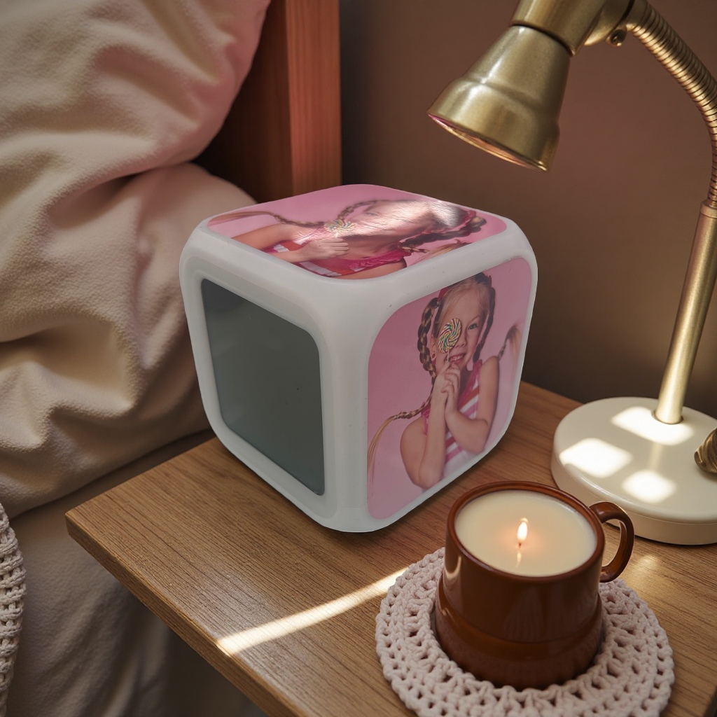 A white cubic alarm clock with a pattern of a girl eating lollipops, a silent bedside display in the bedroom, heat transfer printing Specification image