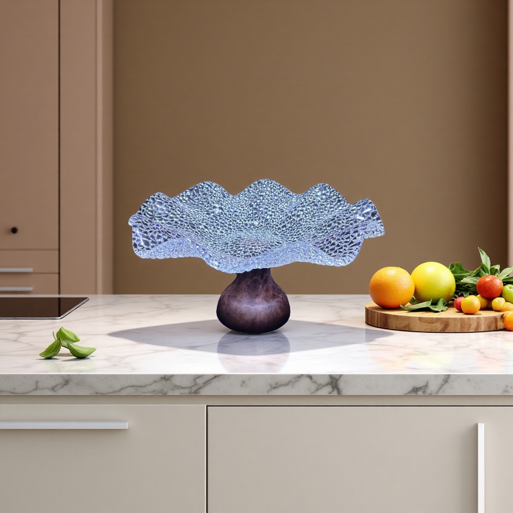 A transparent mesh wavy glass fruit plate with a dark wooden base and a handcrafted glass base plate