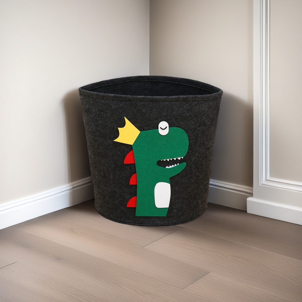 Black felt storage bucket, green cartoon dinosaur pattern, yellow crown, red dorsal fin, white abdomen, single eye smiling