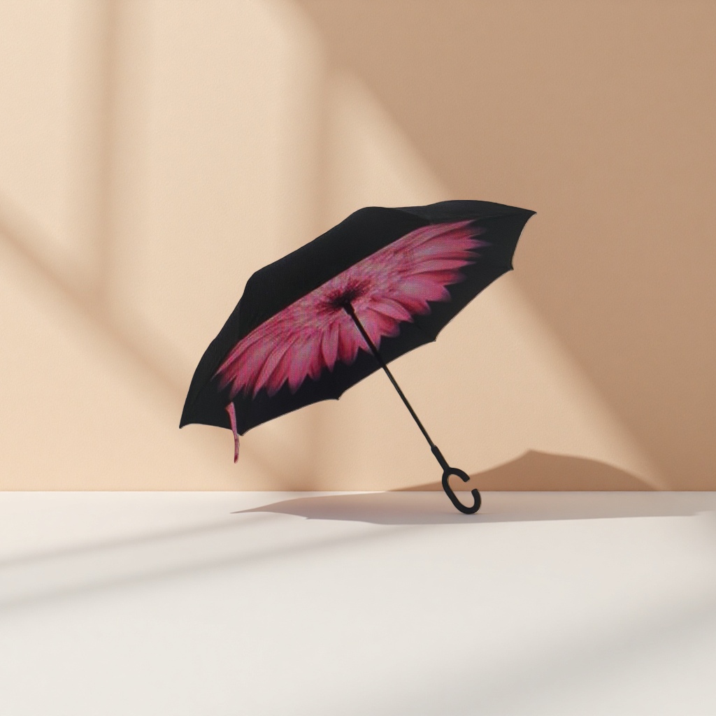 A reverse umbrella with a black canopy and pink flower patterns details Picture