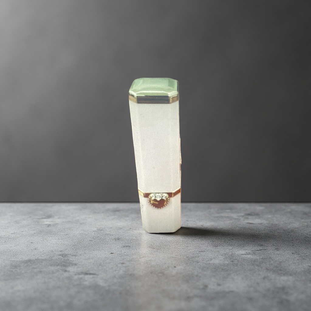 A white lipstick tube with a green cap and golden heart-shaped decoration Application Scenario