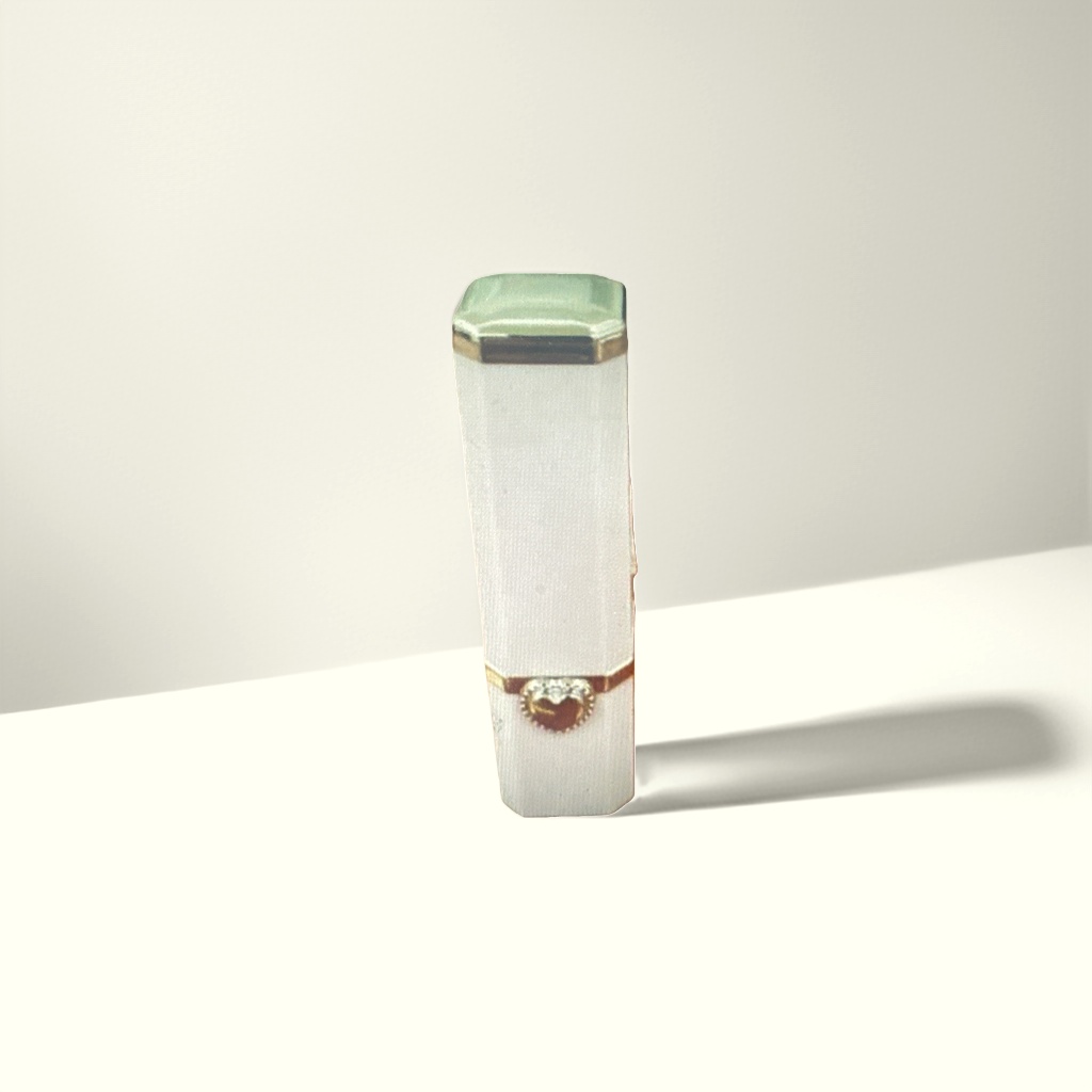 A white lipstick tube with a green cap and golden heart-shaped decoration details Picture