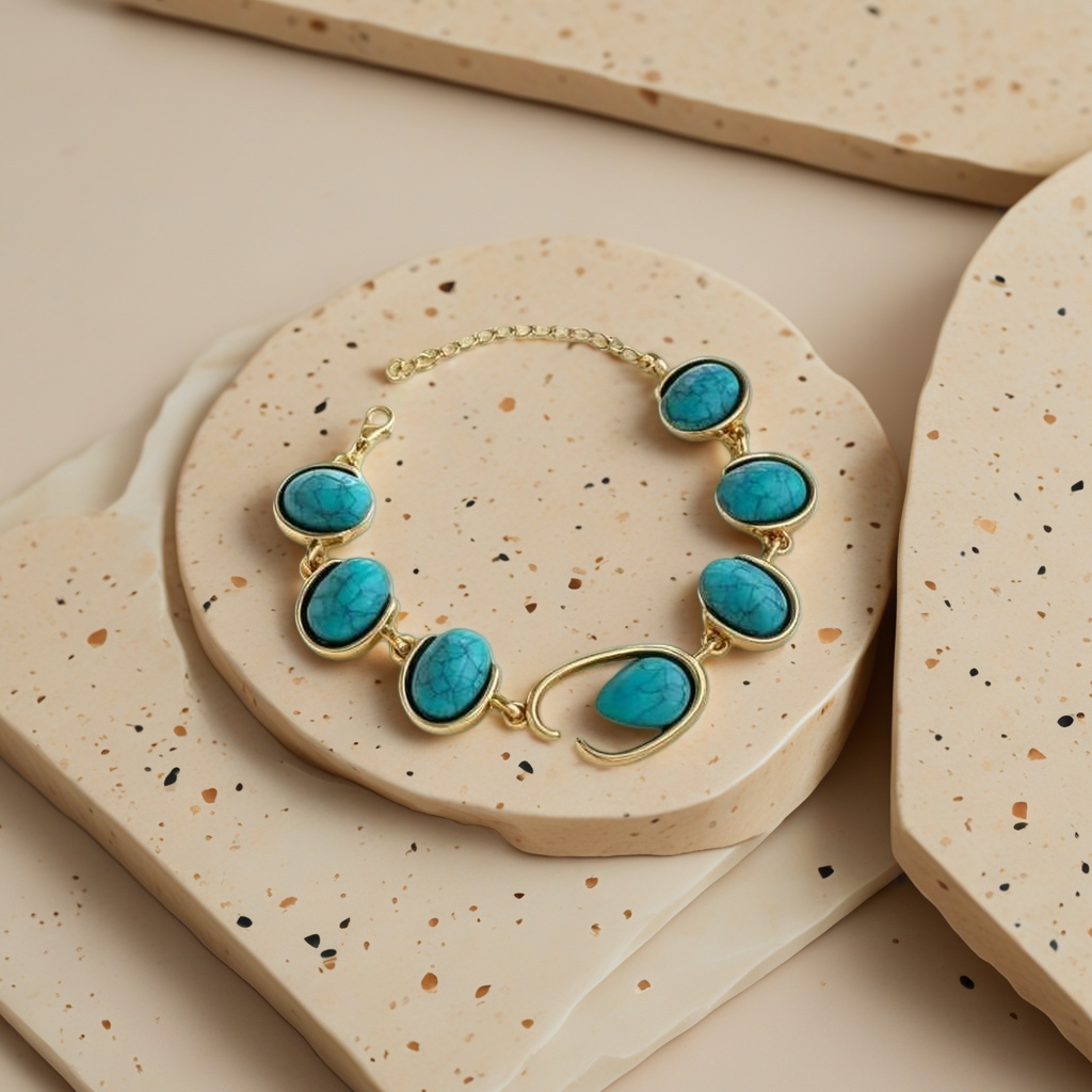 A still life photo display of a golden turquoise bracelet and a white plate