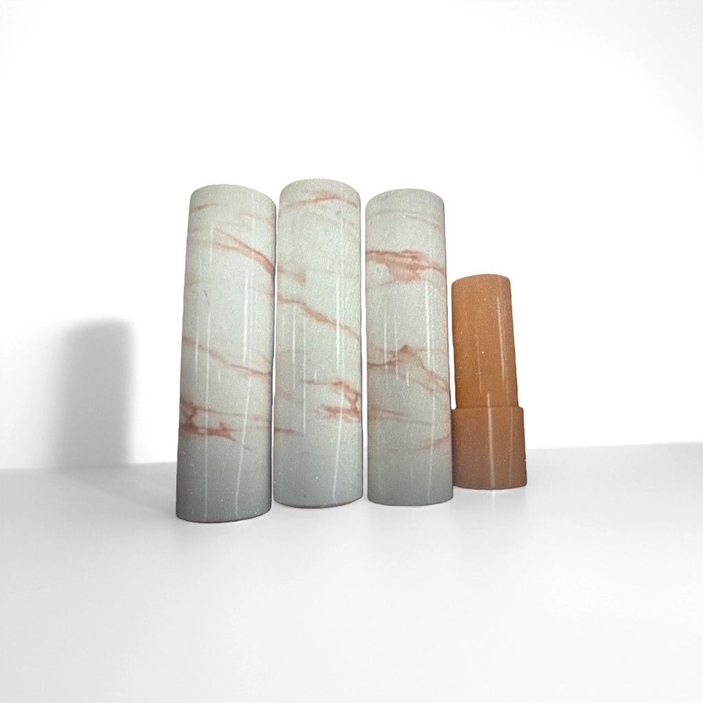 Four marble-patterned tubes are lined up side by side, with an orange tube body on the right side and a lid