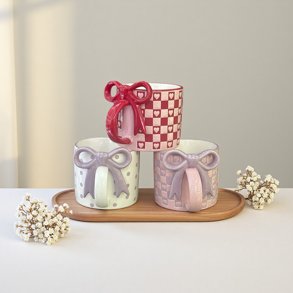 Red and white checkered heart-shaped pattern with a red bow, beige polka dots with a purple bow, and pinkish-purple checkered heart-shaped pattern with a purple bow mug Application Scenario