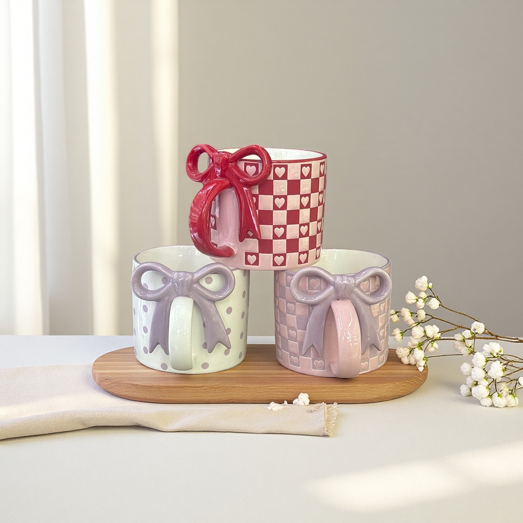 Red and white checkered heart-shaped pattern with a red bow, beige polka dots with a purple bow, and pinkish-purple checkered heart-shaped pattern with a purple bow mug details Picture