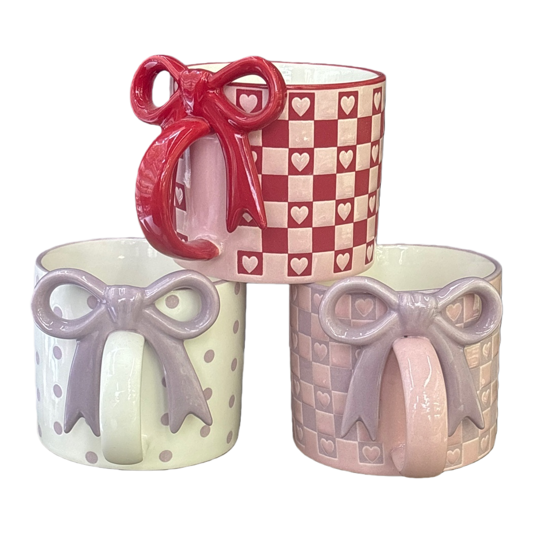 Red and white checkered heart-shaped pattern with a red bow, beige polka dots with a purple bow, and pinkish-purple checkered heart-shaped pattern with a purple bow mug Item Picture