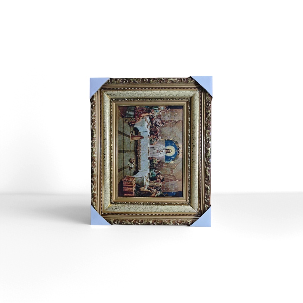 The golden carved photo frame is set with a religious brocade painting of the Last Supper, an arched window and a starry sky background