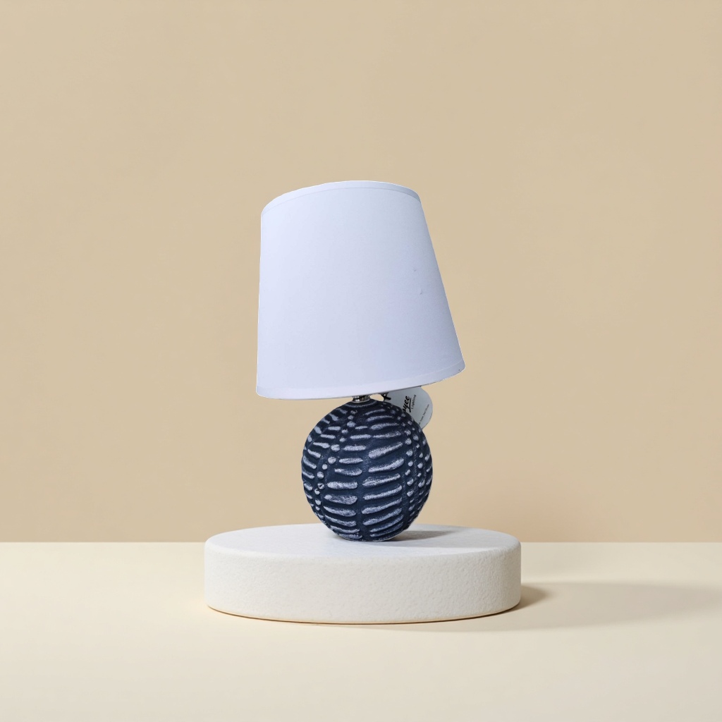 A table lamp with a white lampshade and a deep blue textured spherical base Application Scenario