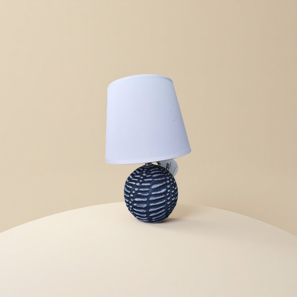 A table lamp with a white lampshade and a deep blue textured spherical base details Picture