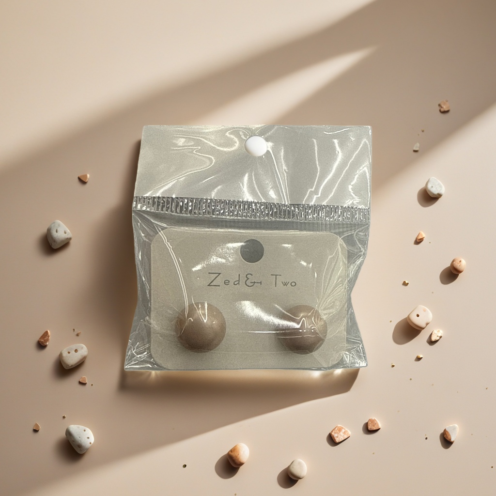 Zed & Two beige ear studs are packaged in transparent plastic bags with brand labels Specification image