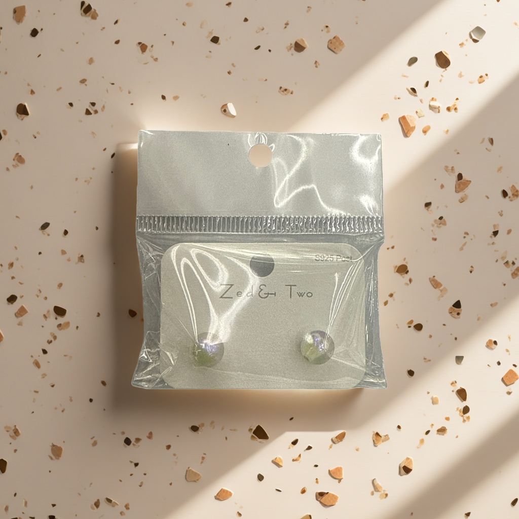 Zed & Two pearl-lustrous round stud earrings are packaged in transparent plastic bags with white card labels Application Scenario
