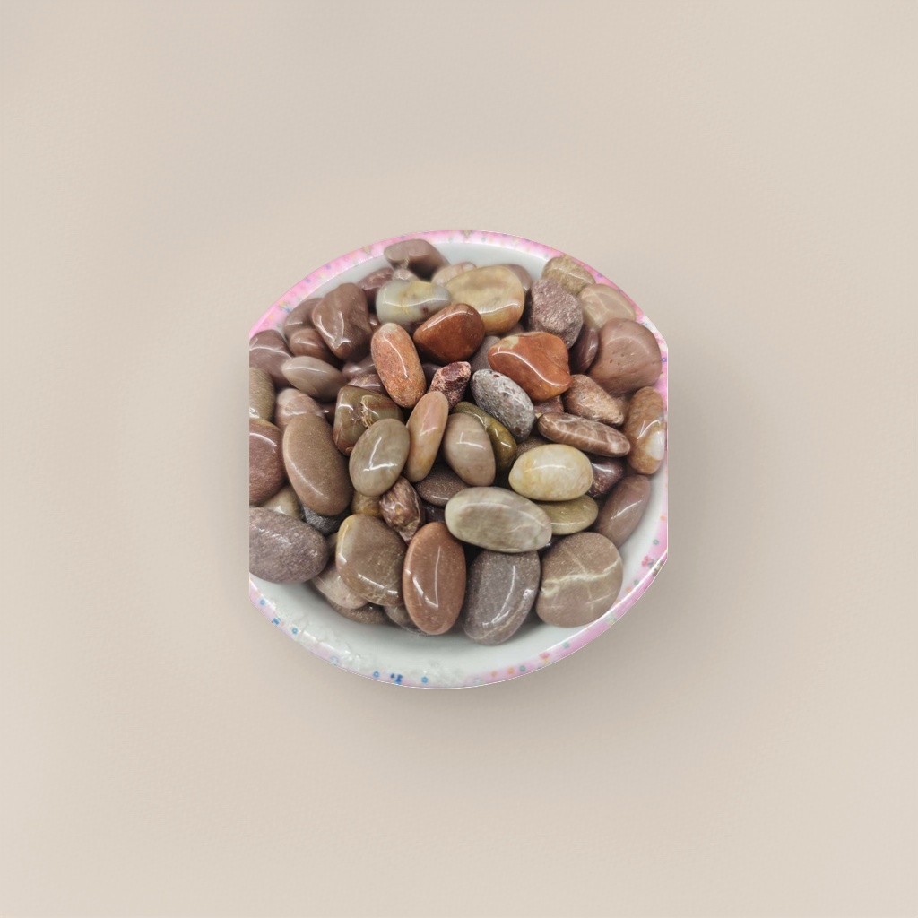 Colorful lace bowls hold various smooth pebble decorative ornaments