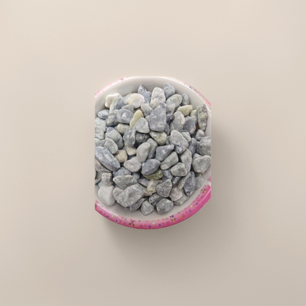 A home decoration piece featuring a ceramic bowl decorated with grey and green pebbles in a colorful lace bowl