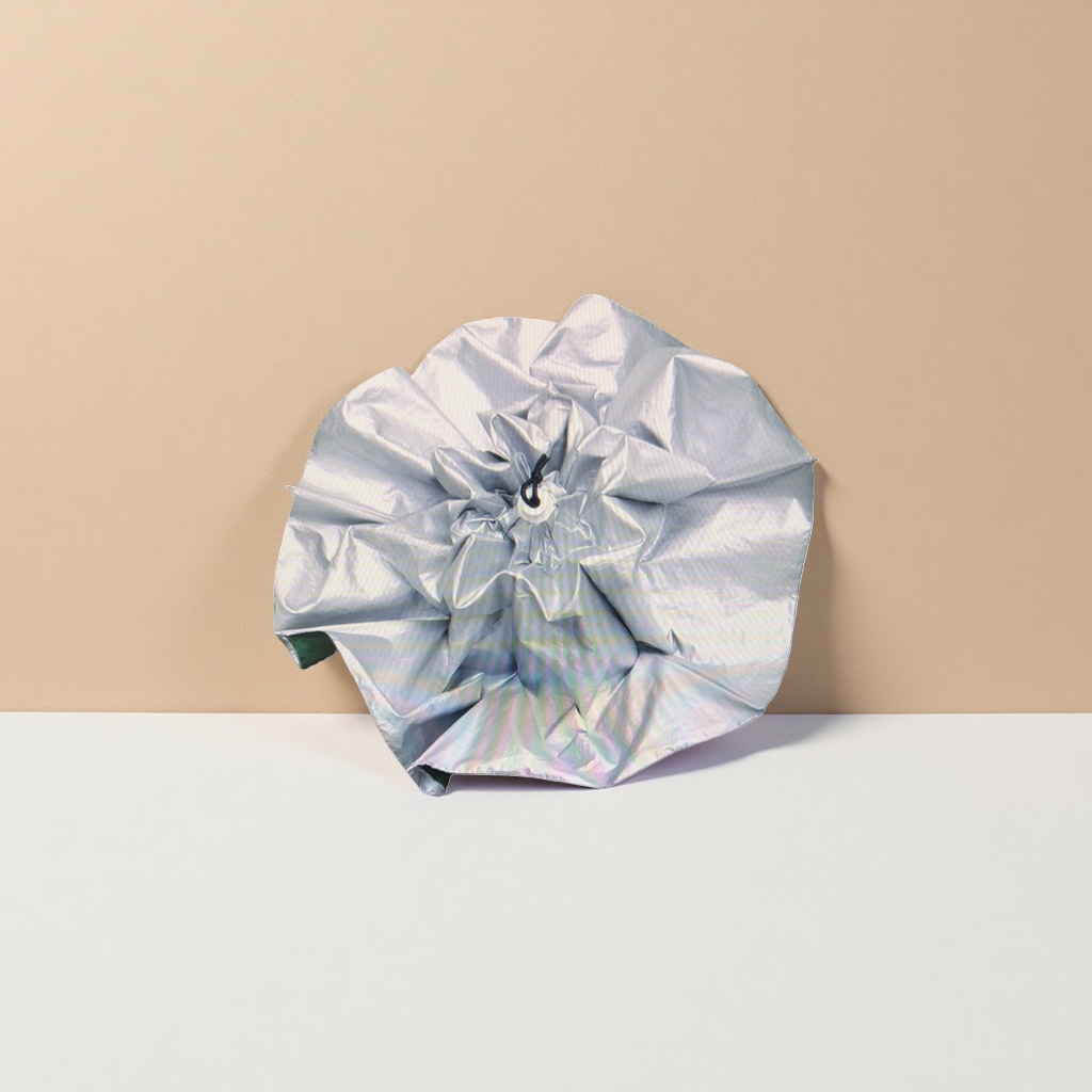 The silver pleated canopy is a versatile folding umbrella that is waterproof, sun-proof, portable and lightweight