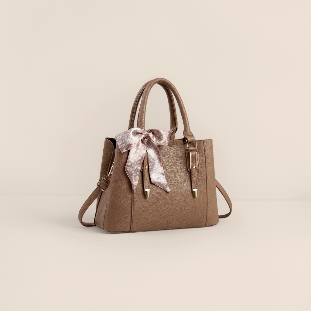 A fashionable commuting bag for women with a brown textured handbag and a white patterned silk scarf bow details Picture