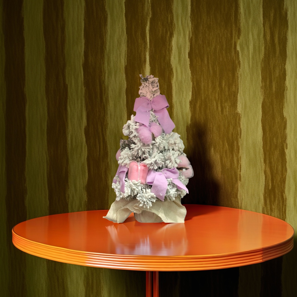 A pinkish-purple bow adorns the white cedar Christmas tree details Picture