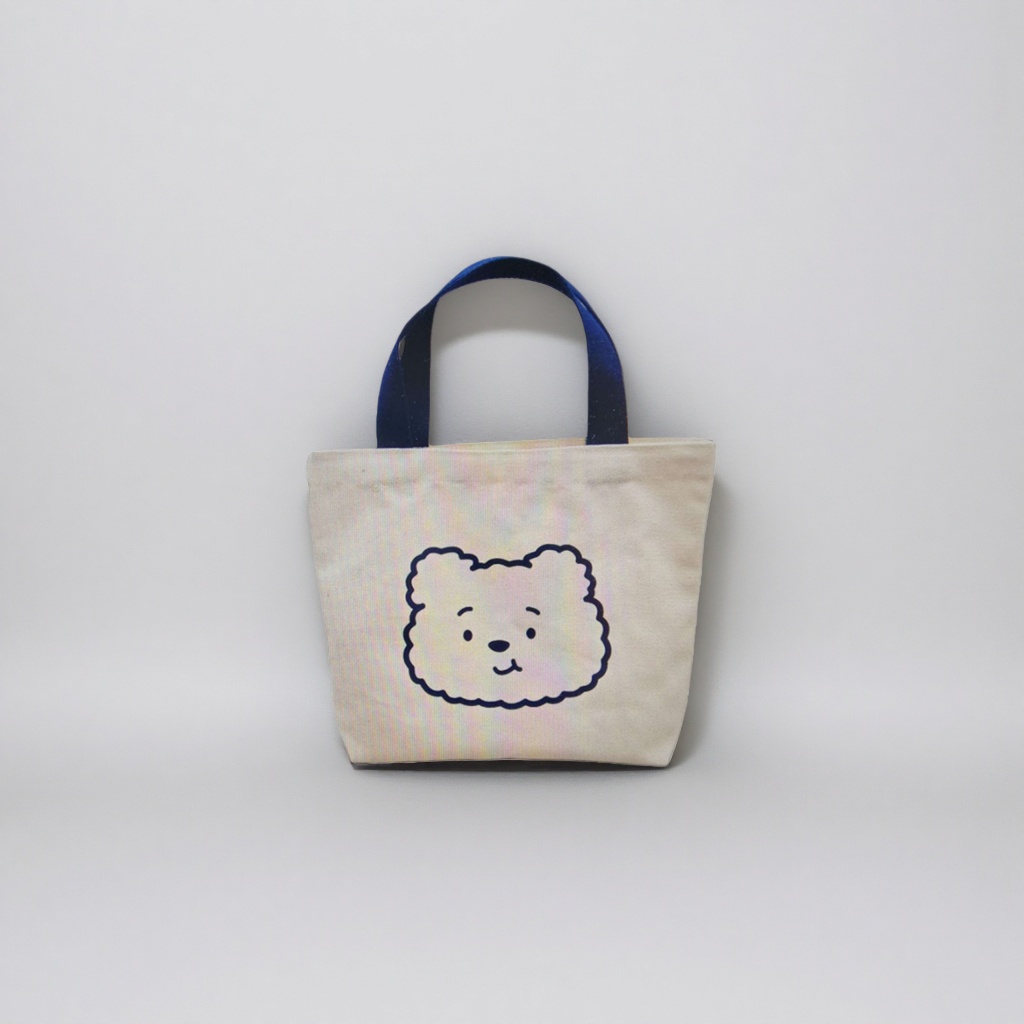 A simple and versatile handbag with a beige canvas bag featuring a cartoon bear face pattern Application Scenario