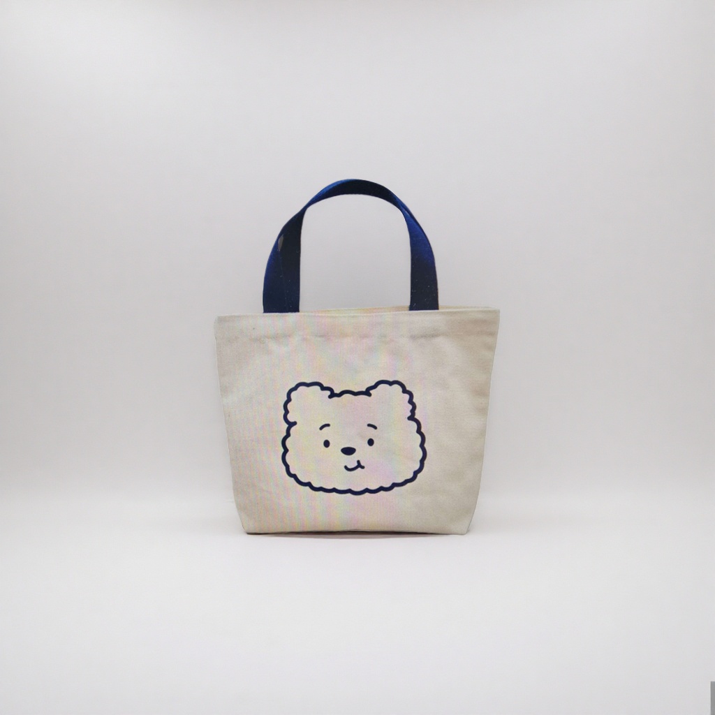 A simple and versatile handbag with a beige canvas bag featuring a cartoon bear face pattern details Picture