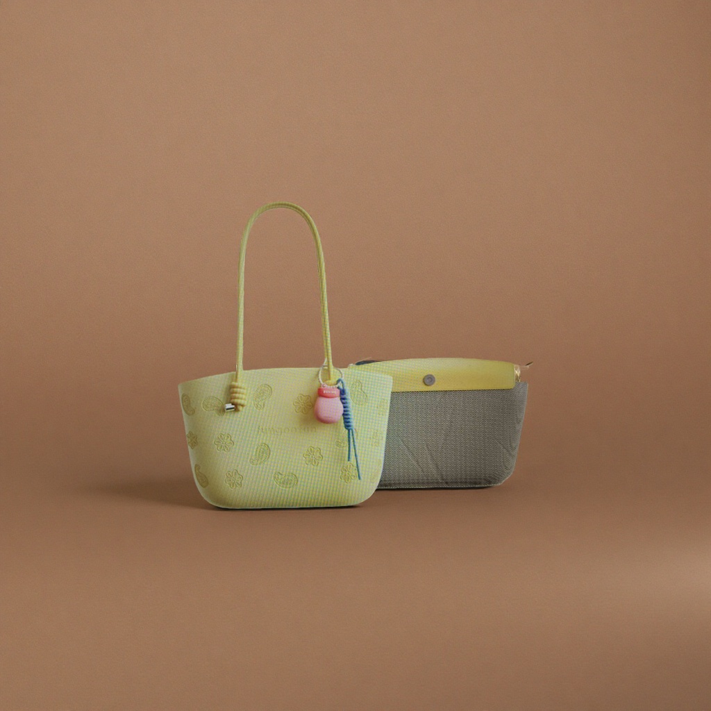 Yellow handbag with Paisley embossing of flowers, pink gourd pendant, blue spiral rope and grey wavy lining details Picture