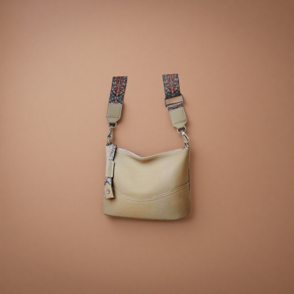 A beige textured leather crossbody bag with a colorful patterned shoulder strap details Picture
