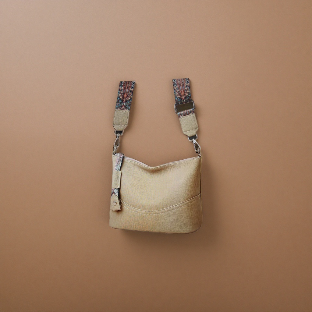 A beige textured leather crossbody bag with a colorful patterned shoulder strap Specification image